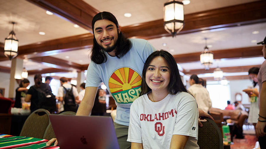 two students smile at the camera